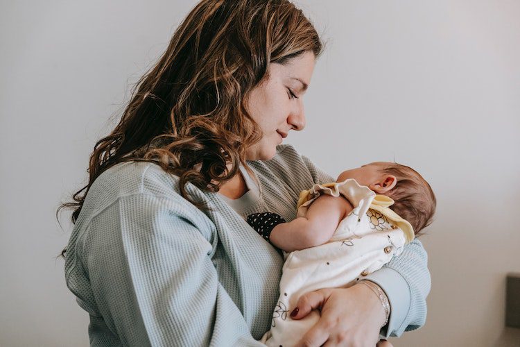 mother holding baby newborn postpartum depression