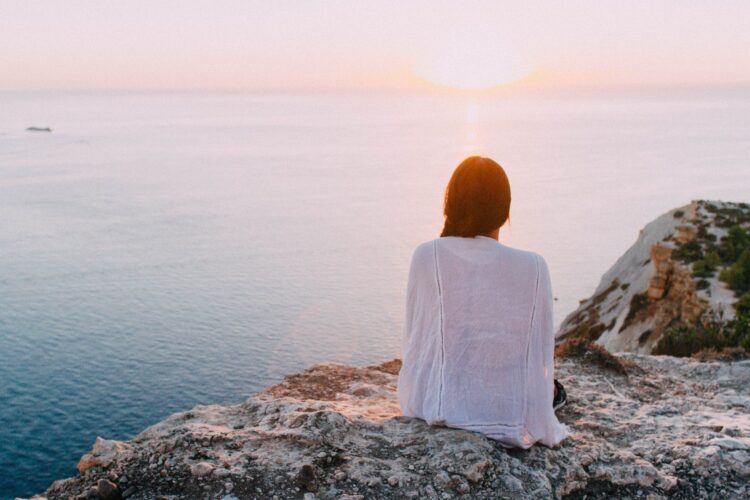 woman watching sunset over ocean