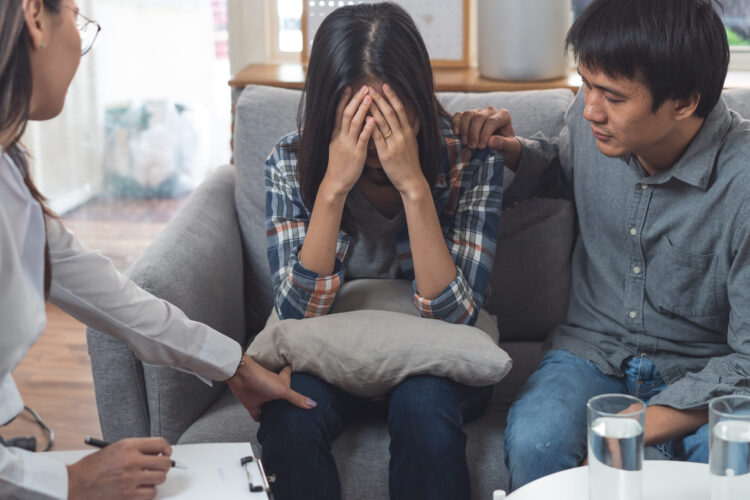 psychologist talking with married couple about depression of husband.