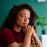 Highland Hospital - 5 Facts About Depression. A woman sits with her eye closed looking upset.